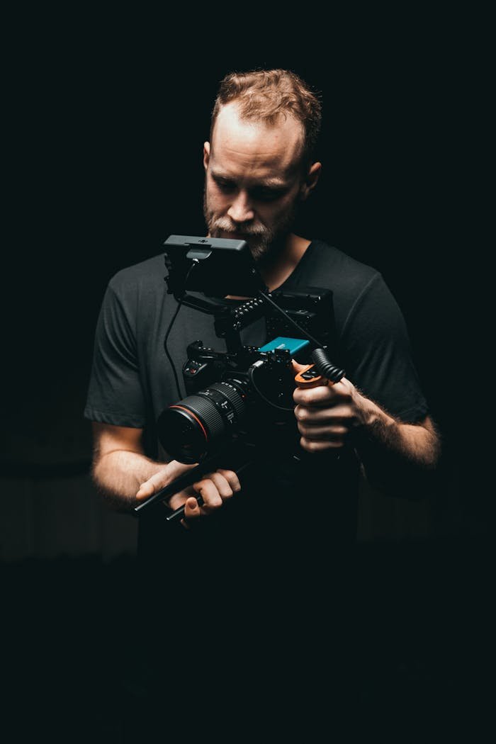 gallery-01 A cinematographer adjusts a camera rig with precision, ready for the next scene.