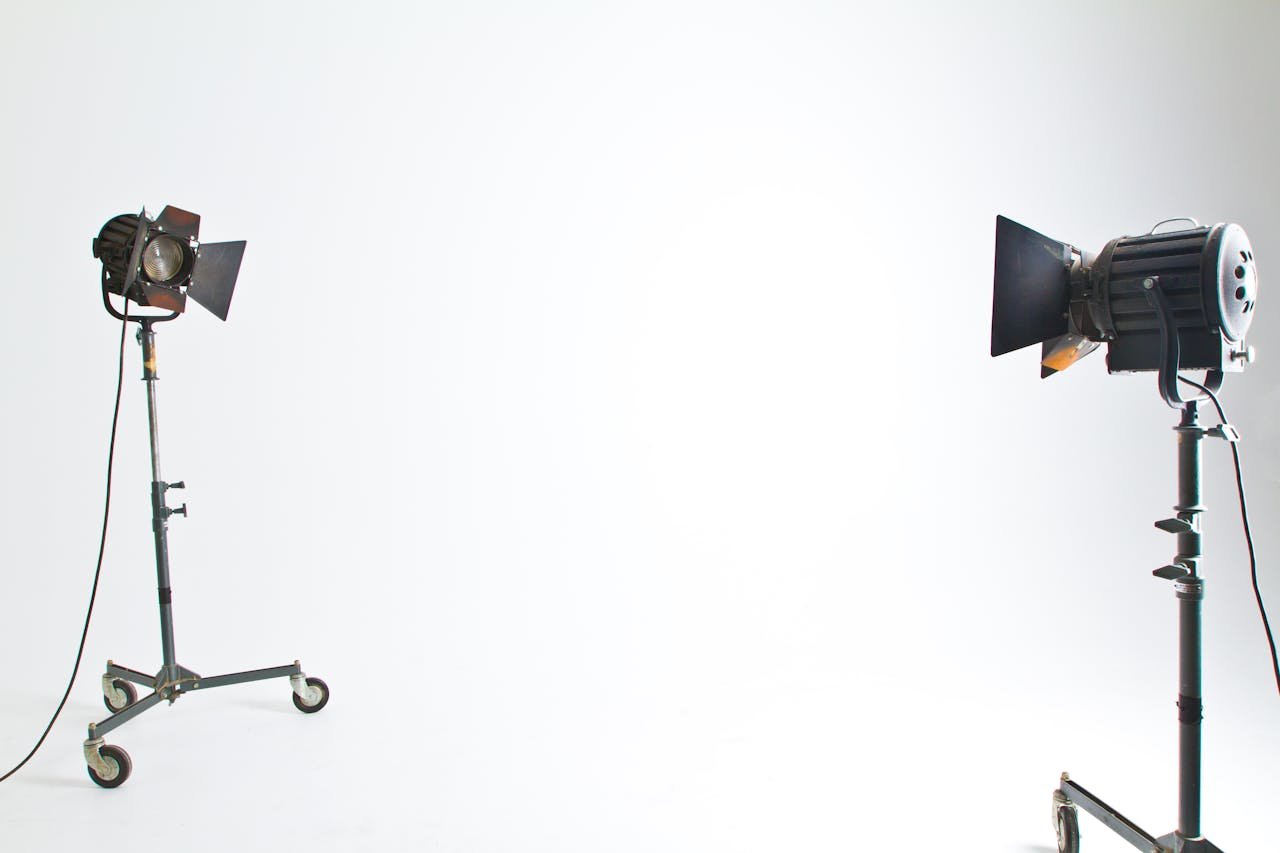 about-img Studio floodlights set up in a professional photography environment with clean background.